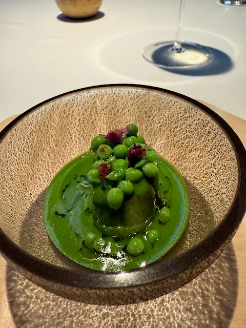 a scallop covered in a vibrant green sauce